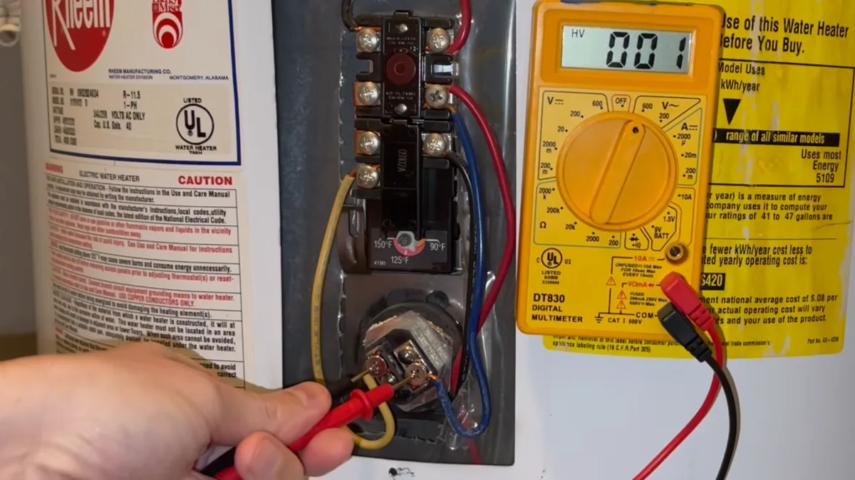 Electrical test meter beside an open water heater control compartment