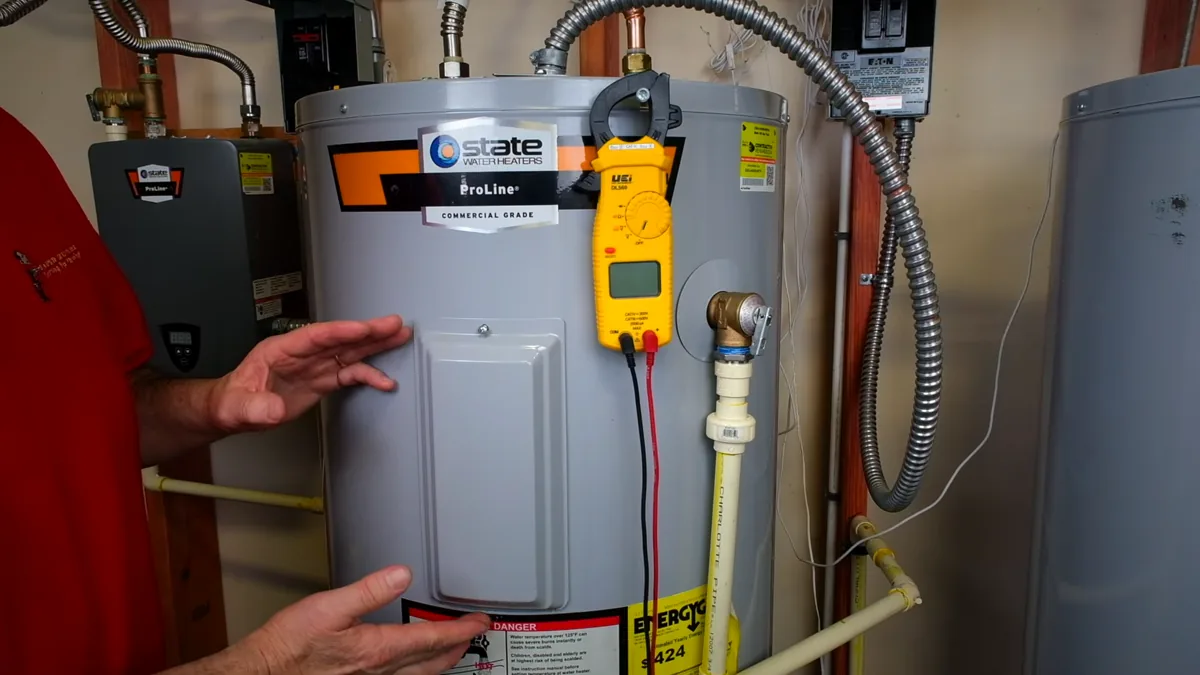 A storage water heater being assessed beside its control panel