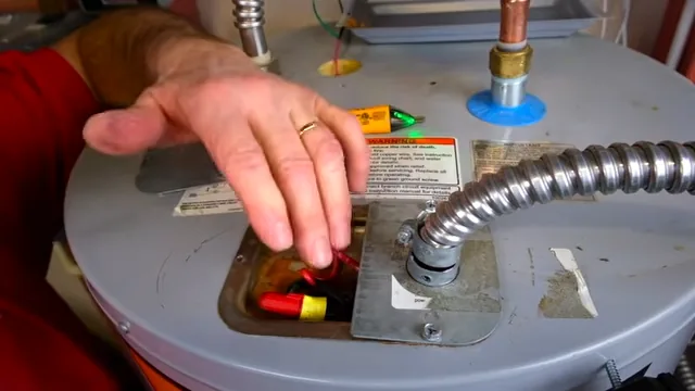 A storage water heater fitting being inspected from above