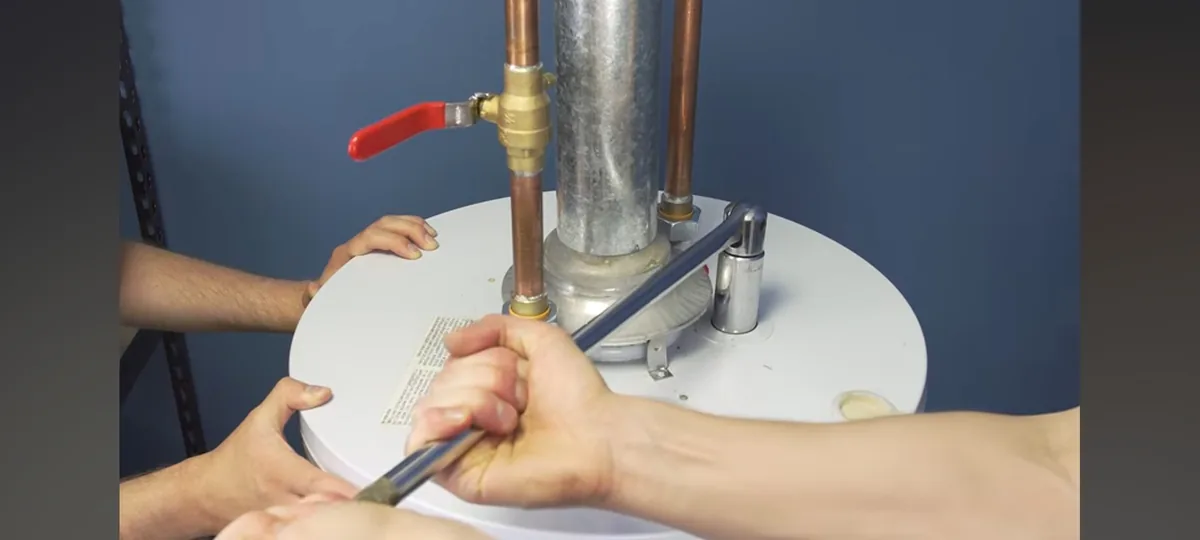An internal rod being examined at the top of a water heater