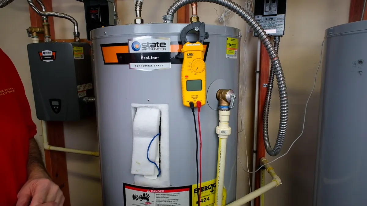 Storage water heater with visible supply pipes and controls