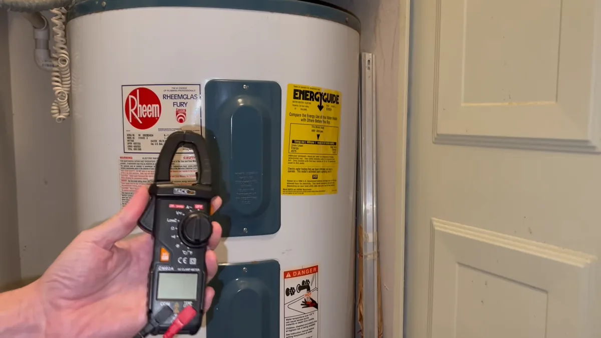 Handheld test meter in front of an electric storage water heater